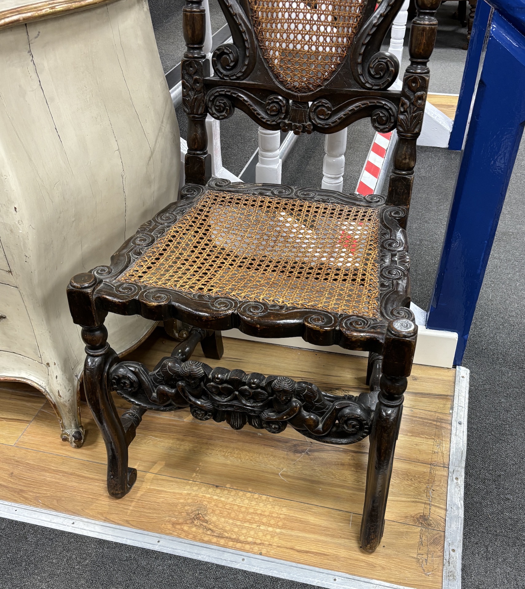 A Charles II carved walnut caned seat and back dining chair, c.1670, width 54cm, height 120cm, Please note this lot attracts an additional import tax of 5% on the hammer price